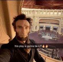 a man dressed as abraham lincoln takes a selfie in front of an auditorium