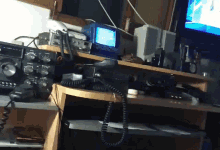 a radio is sitting on a desk next to a monitor and a phone