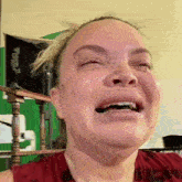 a close up of a woman 's face with tears coming out of her eyes .