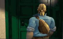 a man standing in front of a green door with his back to the camera