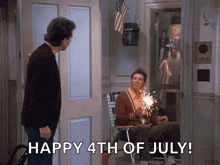a man holding a sparkler says happy 4th of july in front of another man