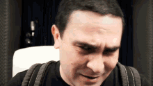 a man with a backpack making a funny face with his mouth open