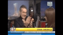 a man is clapping in front of a screen that says steaua on it