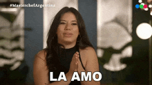 a woman with her hands folded and the word la amo on her face