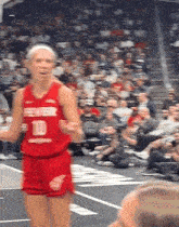 a female basketball player in a red jersey with the number 10 on it