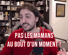 a man in a red shirt with the words pas les mamans au bout d ' un moment