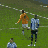 a soccer player wearing a number 21 jersey jumps in the air