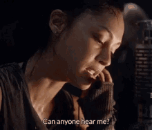 a woman is talking on a cell phone and says `` can anyone hear me ? ''