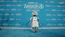a robot is standing in front of a blue wall that says fantastic 4 first steps world premiere