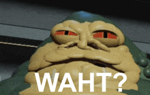 a close up of a cartoon character with waht written on it