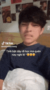a young man is laying in bed with a tiktok watermark
