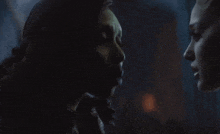 a couple of women looking at each other in the dark