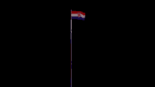 the flag of croatia is flying in the wind on a black background