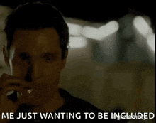 a man is smoking a cigarette while talking on a cell phone and the text says `` me just wanting to be included ''
