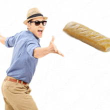 a man in a hat and sunglasses is throwing a loaf of bread into the air