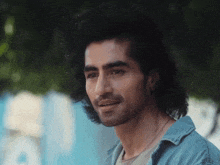 a close up of a man 's face with the letter a behind him