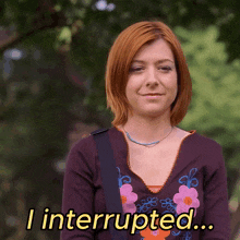a woman in a purple shirt says i interrupted in yellow letters