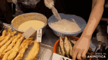 a person preparing food with a sign that says " made in animotica "