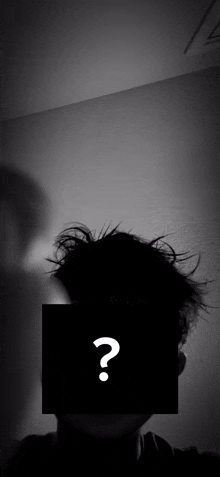 a black and white photo of a person 's face with a question mark on it