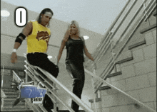 a man and a woman are walking up a set of stairs with the number 0 behind them