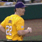 a man wearing a yellow jersey with the number 22 on the back