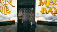 two women are walking down a runway in front of a mega bay sign