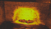a brick fireplace with a yellow glowing fire