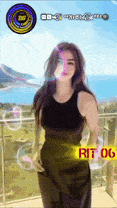 a woman in a black tank top is standing on a balcony with a sign that says rit 06 on it