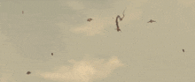 a man is flying through the air while holding a light saber .