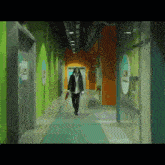 a person walking down a hallway with a sign on the wall that says ' a '