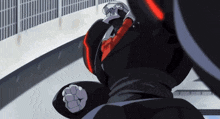a robot with a red shirt on is standing in front of a building