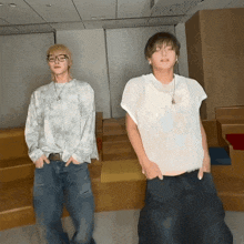 a man in a tie dye shirt is dancing with another man in a white shirt