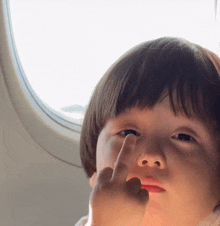 a young boy is giving the middle finger