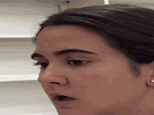 a close up of a woman 's face with a surprised expression