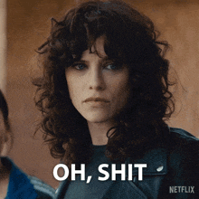 a woman with curly hair says oh shit in front of her