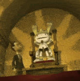 a cartoon character is sitting on a throne next to a man in a suit and tie