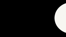 a man in a suit walks through a circular hole
