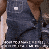 a man wearing overalls is standing in a room and talking to someone .