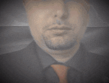 a man with a beard wearing a black shirt and a tie