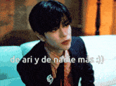 a man sitting on a couch with the words de ari y de nadie mas written above him