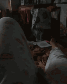 a person in pajamas is laying on a bed with their legs crossed .