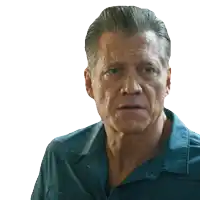 a close up of a man 's face with a blue shirt on