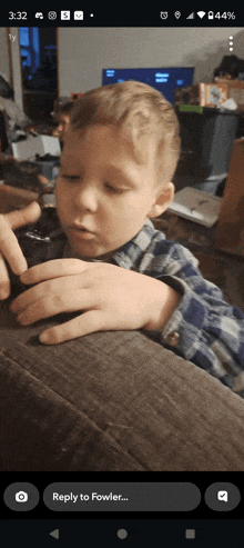 a phone screen shows a picture of a child and says reply to fowler at the bottom