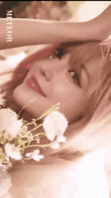 a close up of a woman 's face with a bouquet of white flowers .