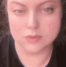 a close up of a woman 's face with her eyes closed