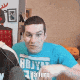 a man wearing a blue shirt that says " da furq " on it