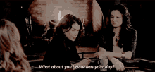 two women are sitting in front of a fireplace and one of them says " what about you "