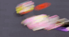 a blurred image of a person playing with a spinning top