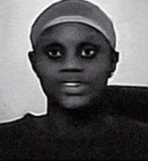 a black and white photo of a person with a hat on