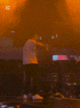 a blurred image of a man on stage with the caption cap cut